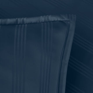 Navy blue fabric with pleated texture on a dark background