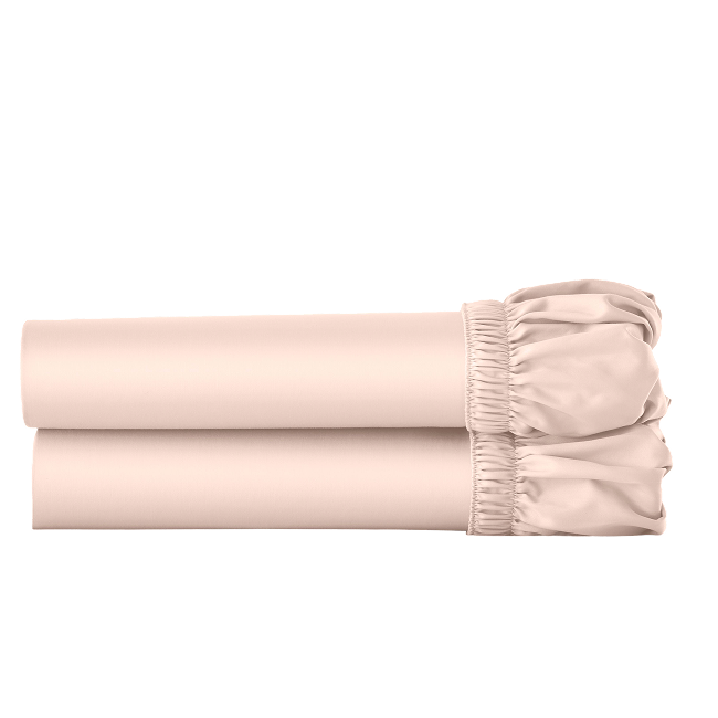 Two pink cotton fitted sheets folded and stacked.