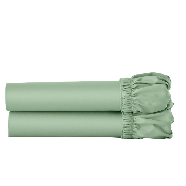 Two green cotton fitted sheets folded and stacked.