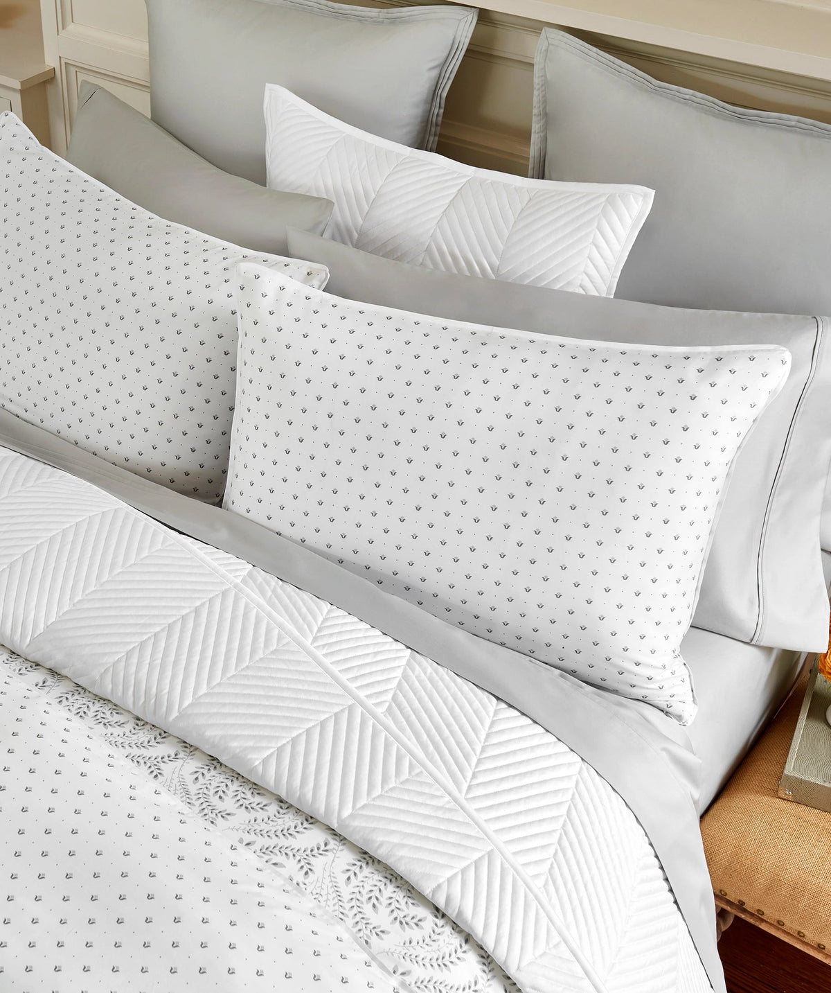 Layered grey and white botanical duvet cover set featuring the coordinating reverse.