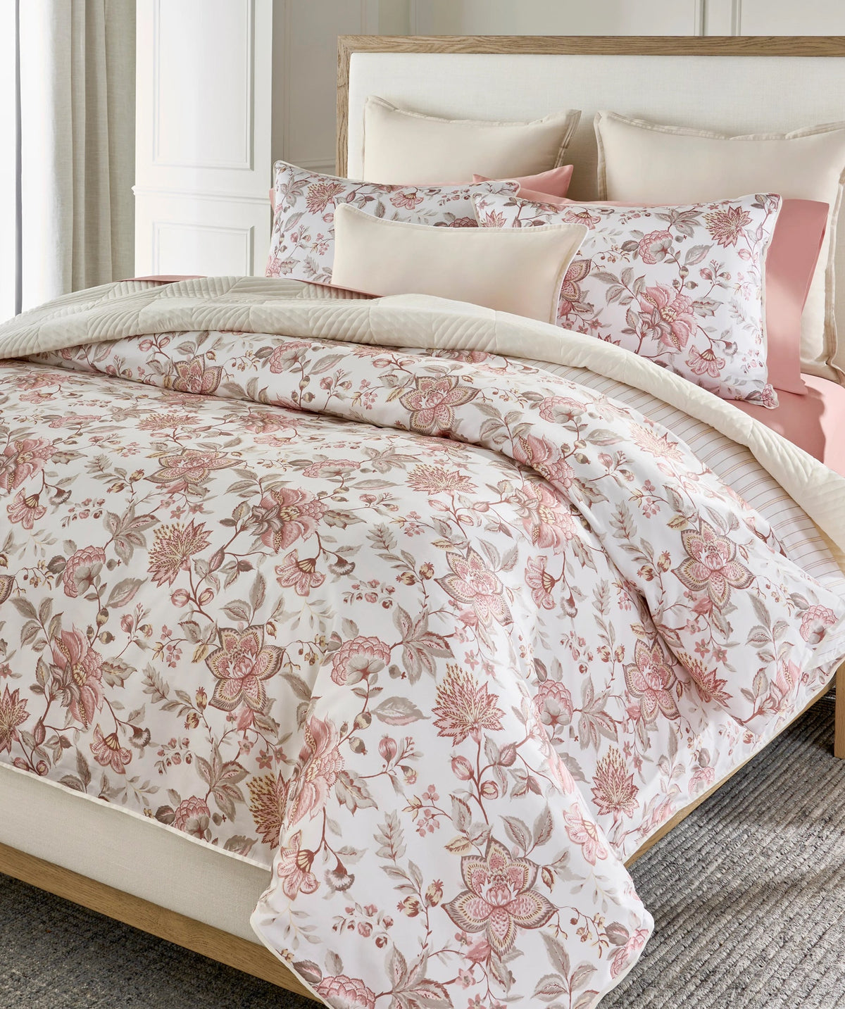 Pink floral duvet cover set styled on a bed.