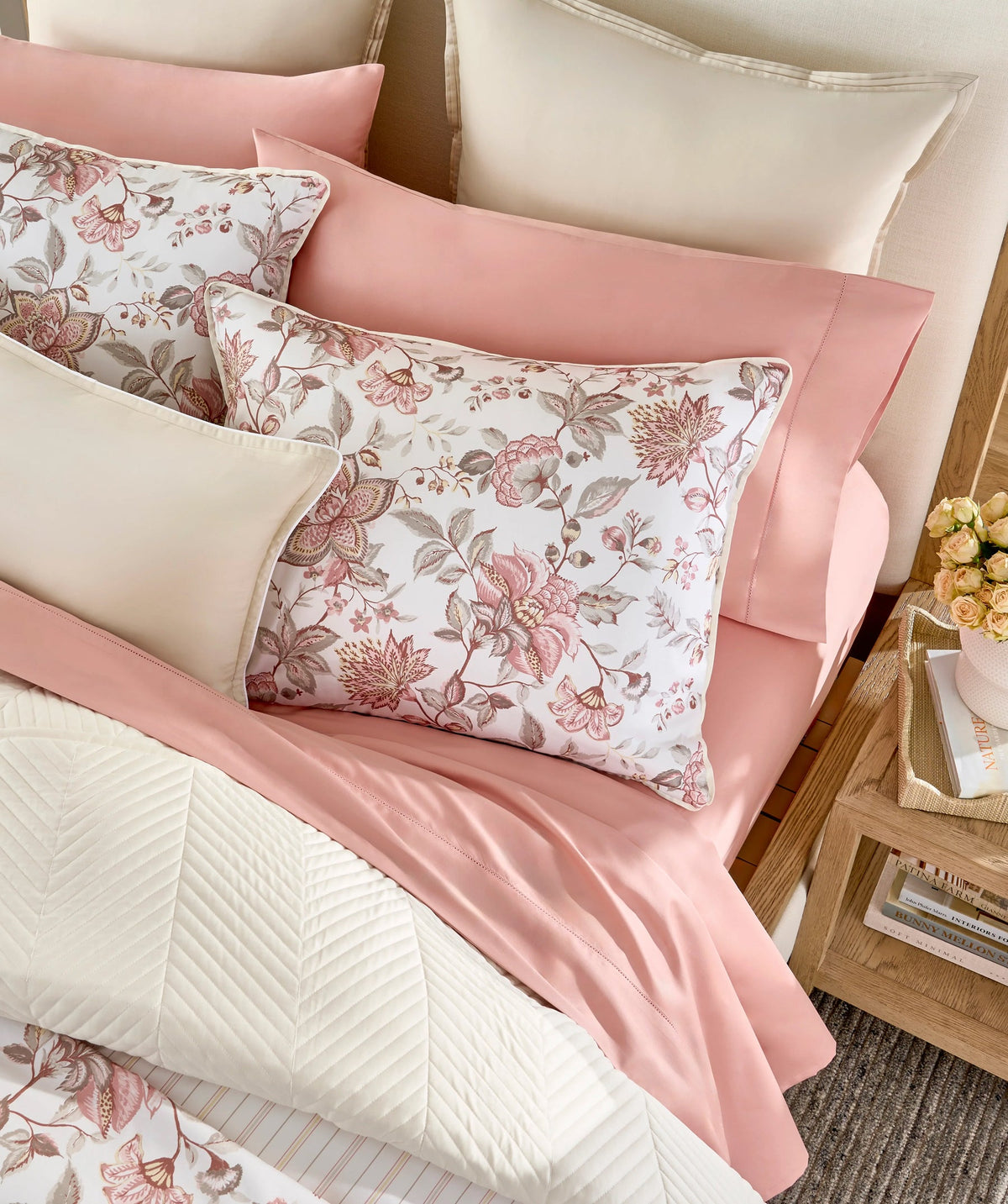 Layered pink floral duvet cover set with coordinating pink bedding.
