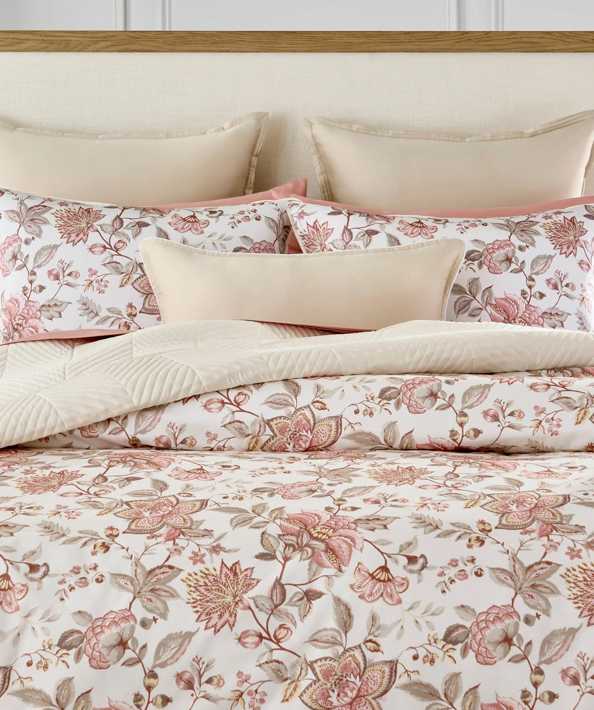Pink floral duvet cover set with coordinating accent pillows.