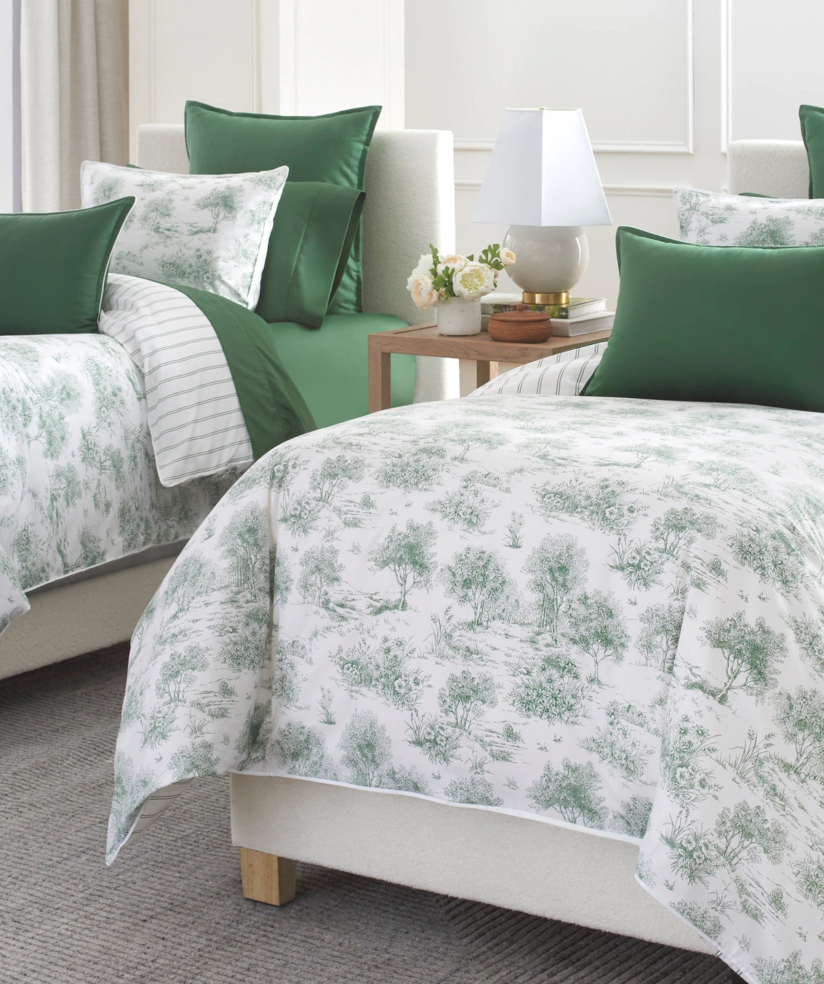 Green garden toile duvet cover set styled on a bed.