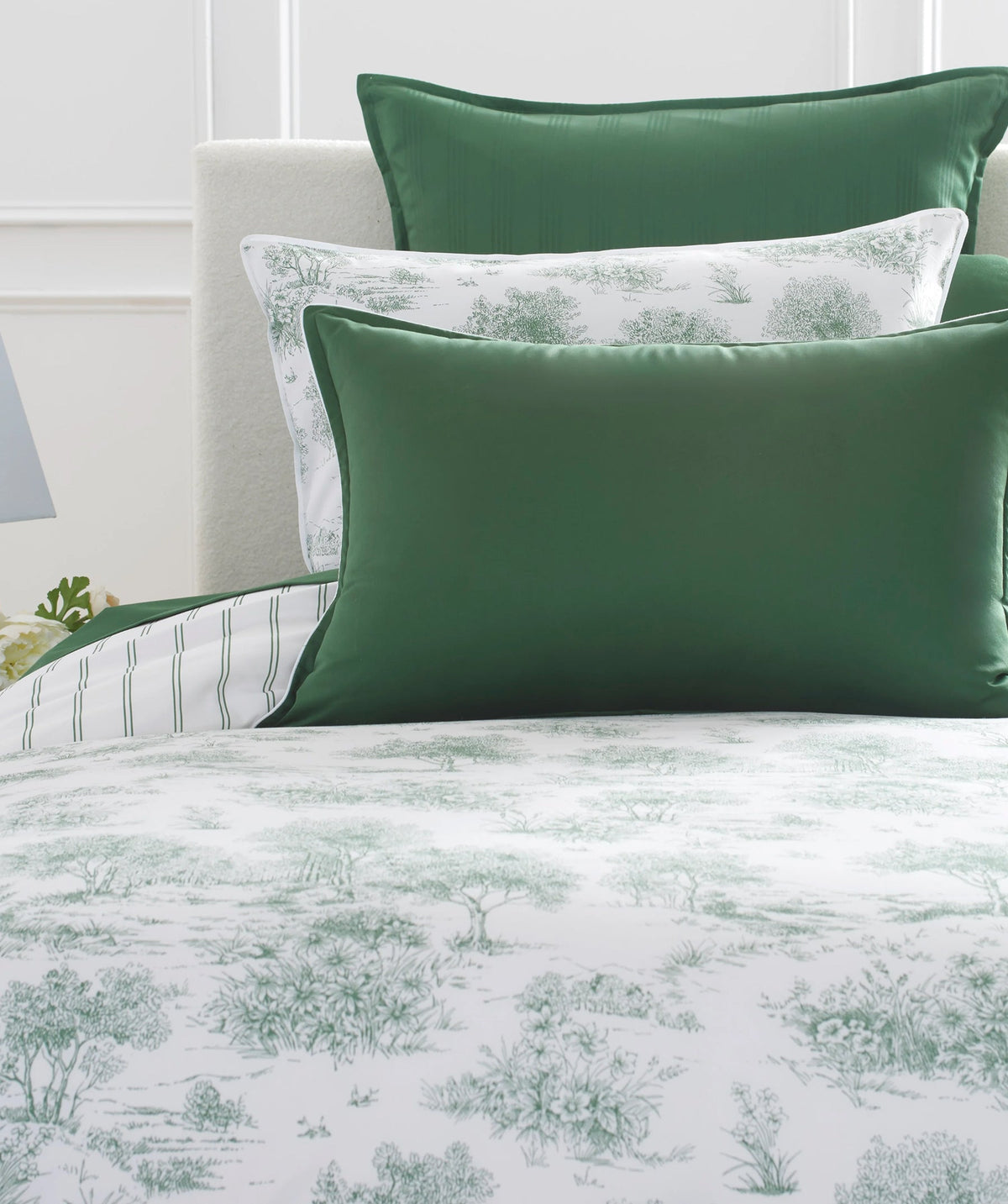 Green garden toile duvet cover set styled on a bed.