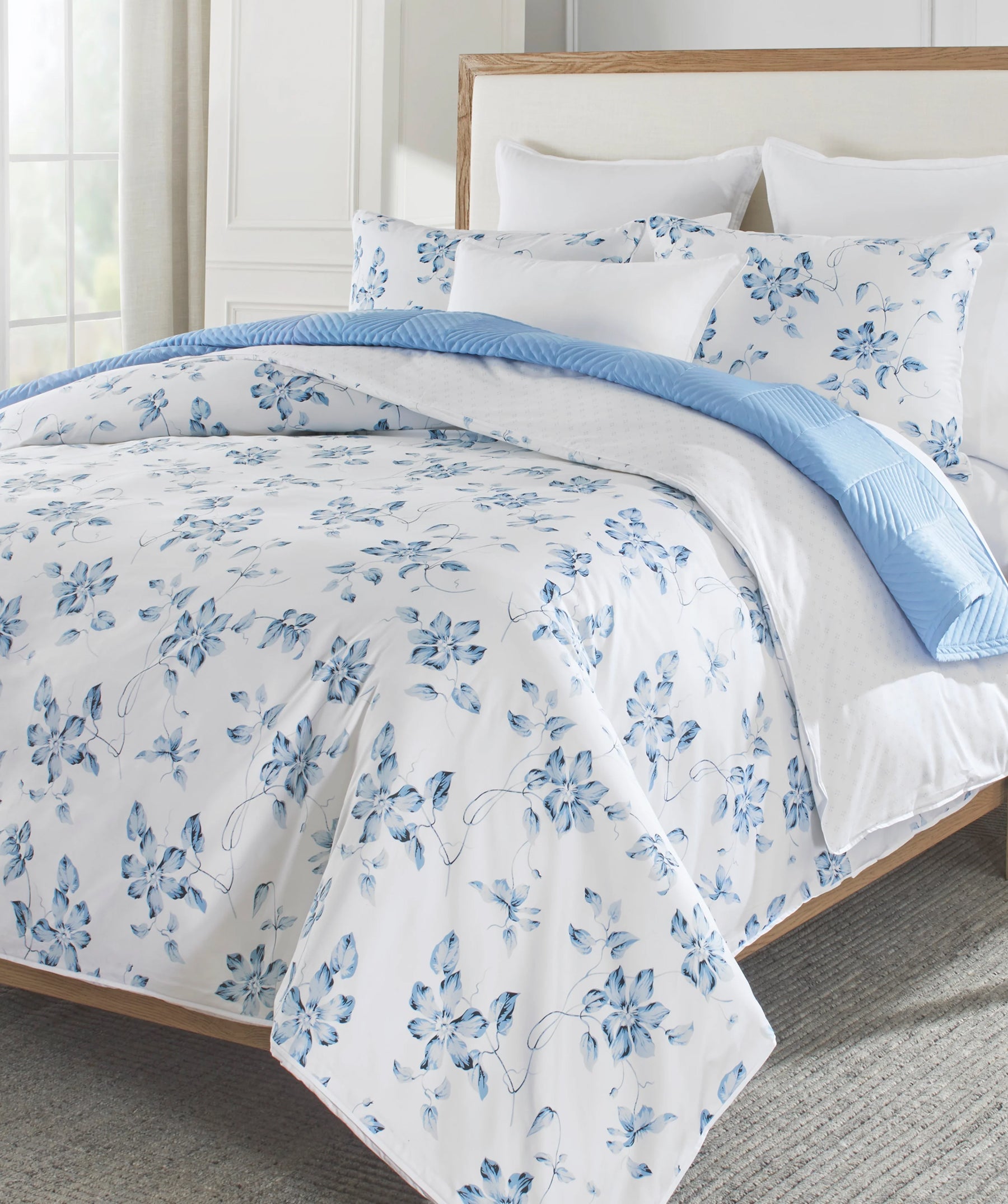 Blue floral duvet cover set styled on a bed.