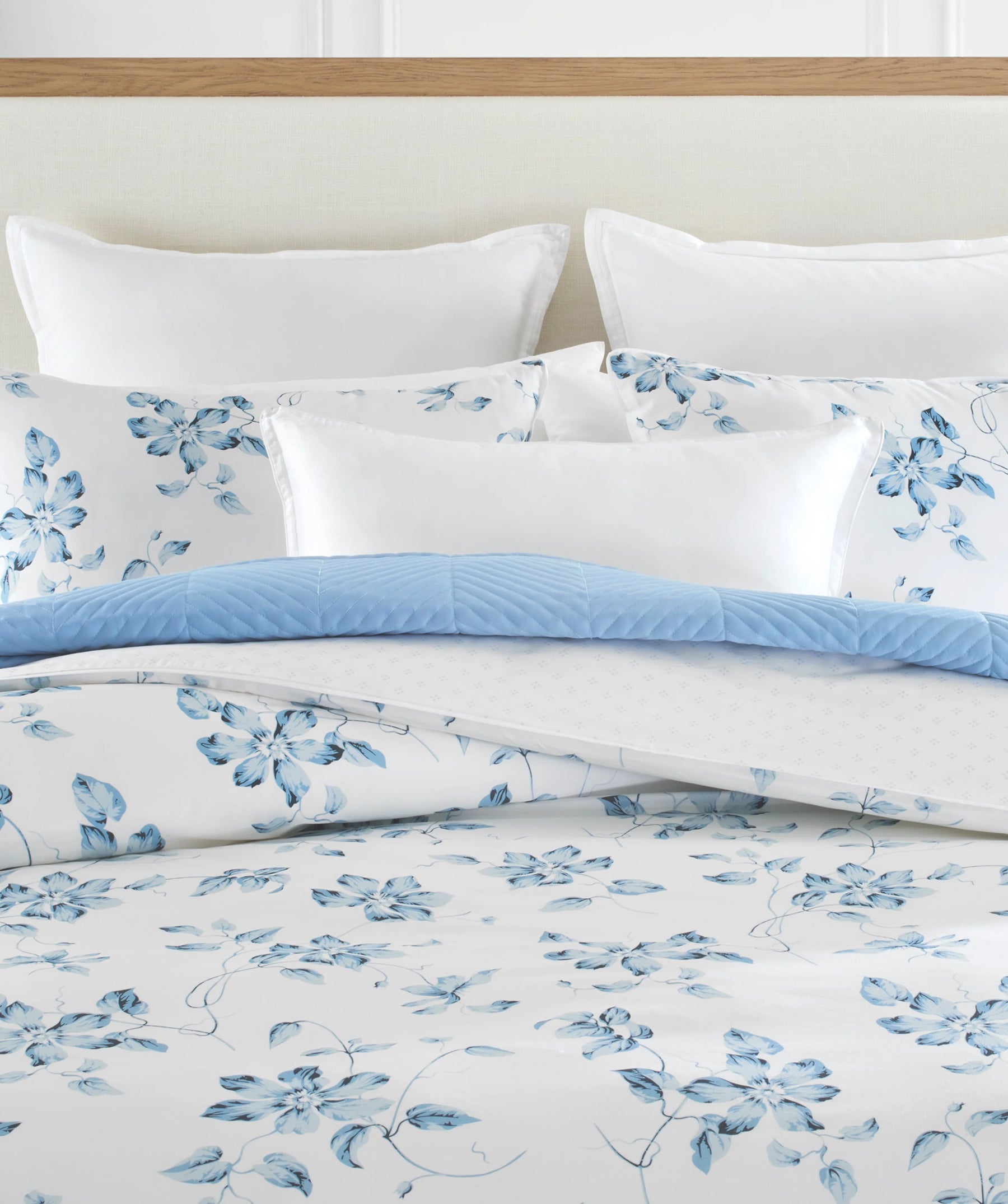 Blue floral duvet cover set with coordinating accent pillows.
