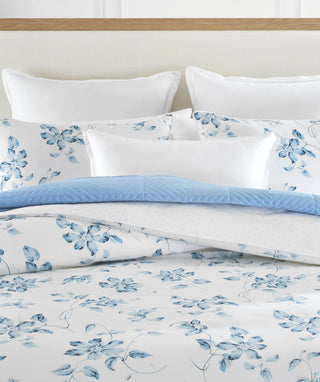 Blue floral duvet cover set with coordinating accent pillows.