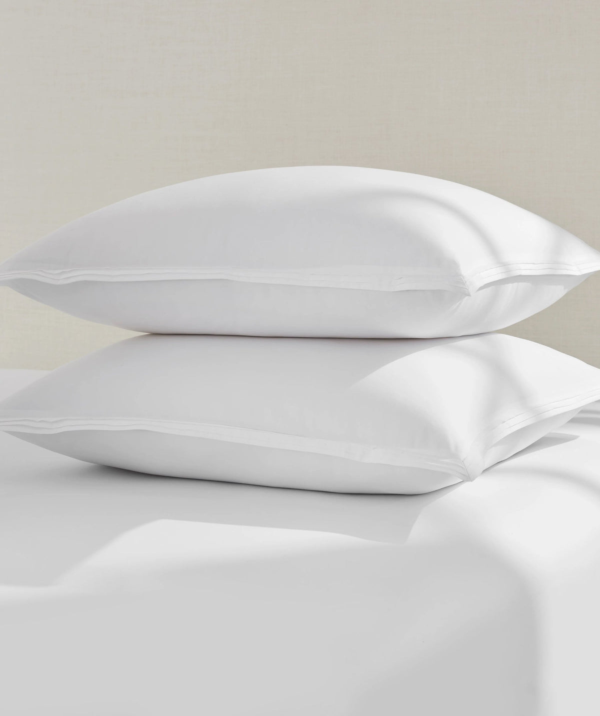 Two stacked white percale euro shams.