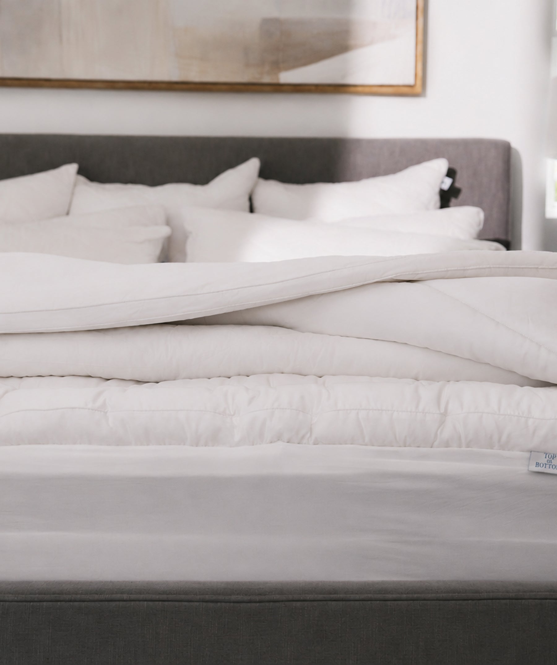 White pillow top mattress topper folded back to show thickness.