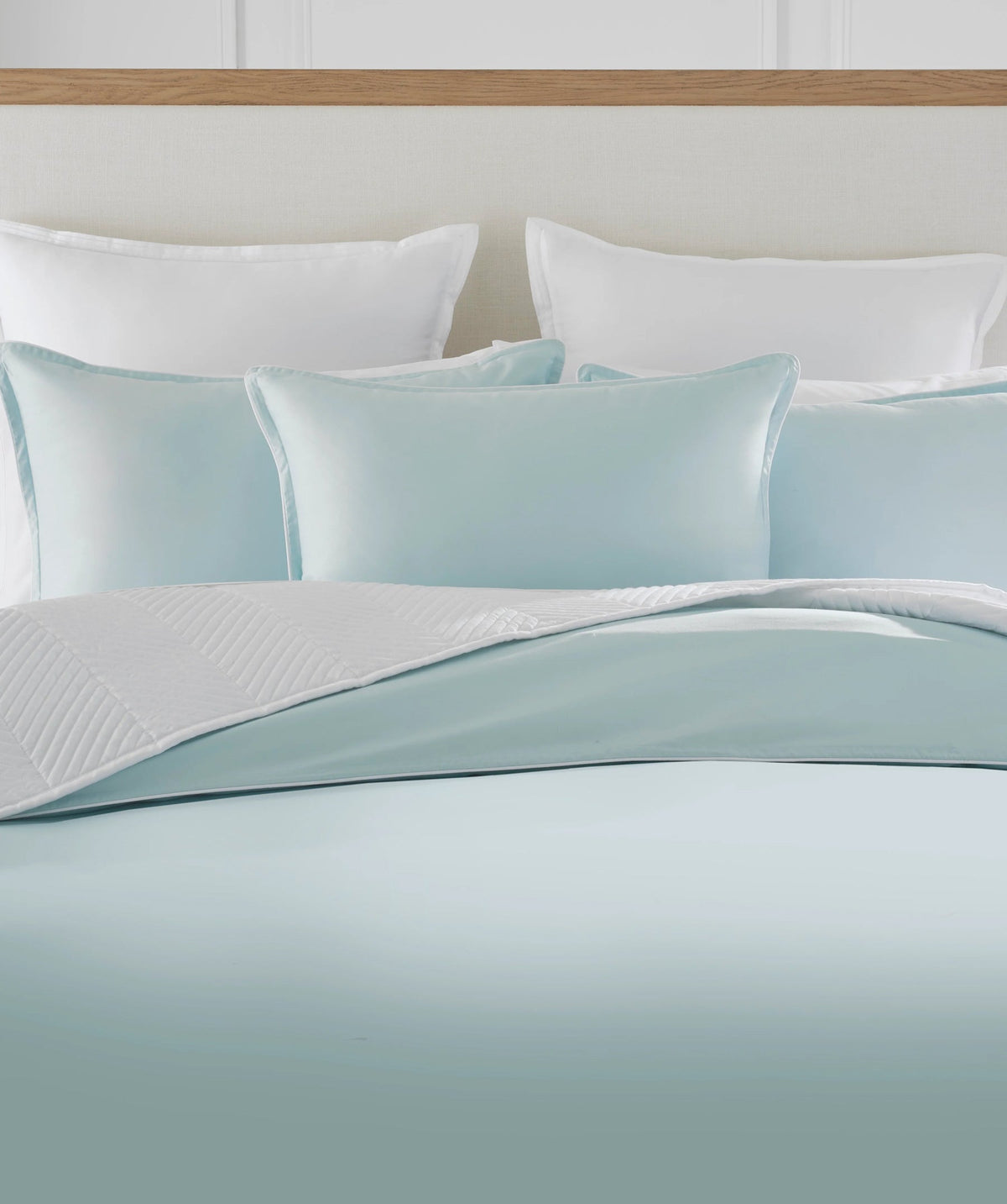 Pastel blue solid duvet cover set styled on a bed.