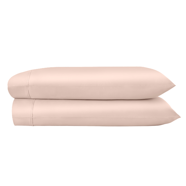 Two pink pillowcases folded and stacked.  
