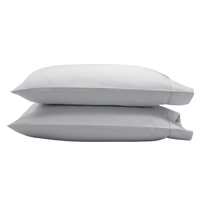 Two light grey pillowcases stacked on top of each other.