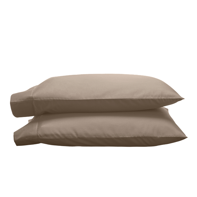 Two tan pillowcases stacked on top of each other.
