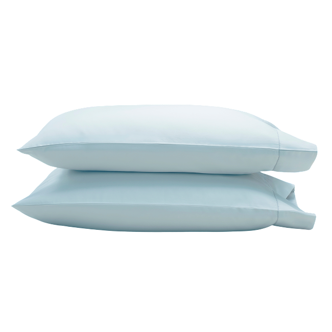 Two pastel blue pillowcases stacked on top of each other.