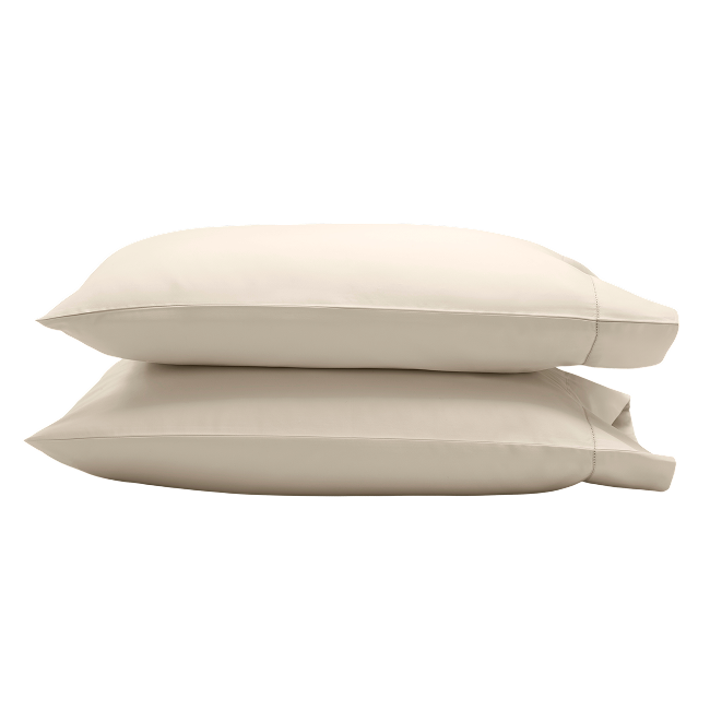 Two beige pillowcases stacked on top of each other.
