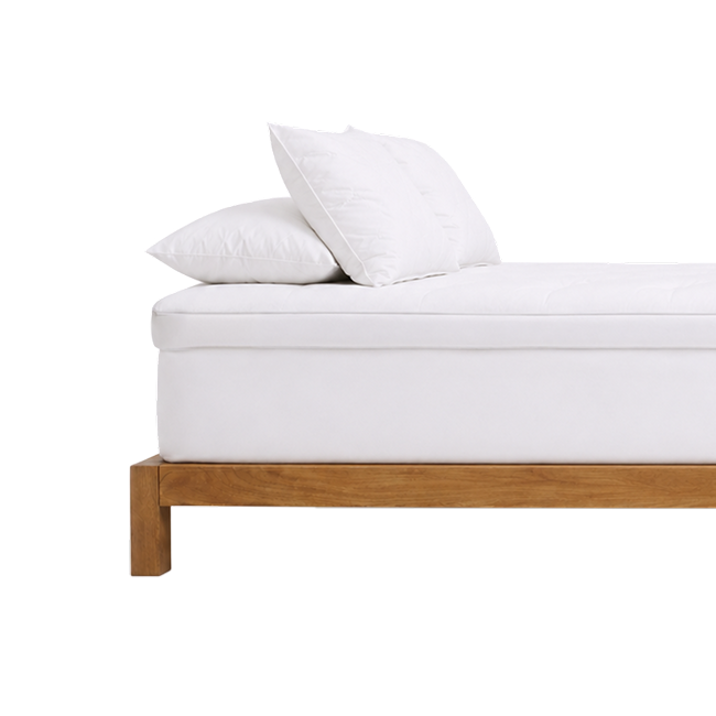 White pillow top mattress topper shown on a mattress.